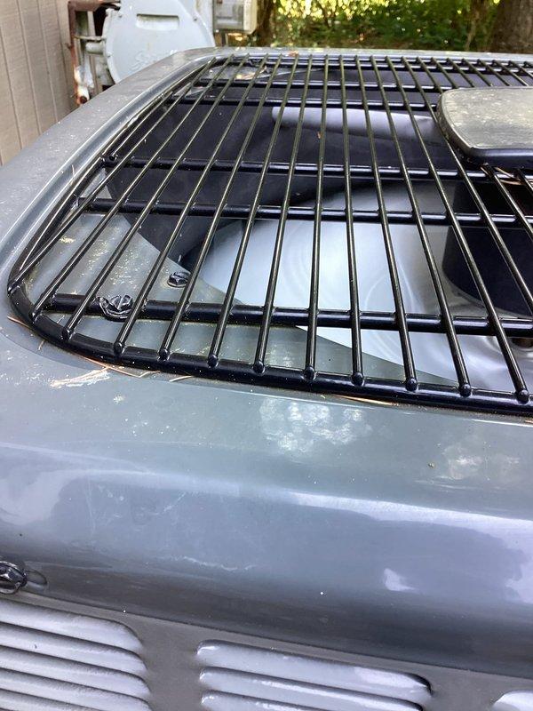 Responded to noise complaint regarding rattling outdoor condenser unit. Inspected and tightened all mounting screws securing the top protective fan grille to the unit housing, which had worked loose and were causing vibration noise during operation. Verified grille is now properly seated and secured, eliminating the rattling issue.