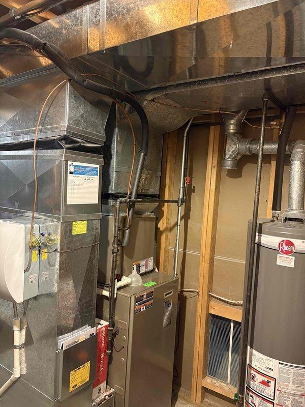 Completed installation of manual control humidifier system in residential basement mechanical room. Unit was properly mounted, connected to existing HVAC ductwork, and integrated with water supply line using PVC piping. System was tested and left operational for improved indoor air quality control.