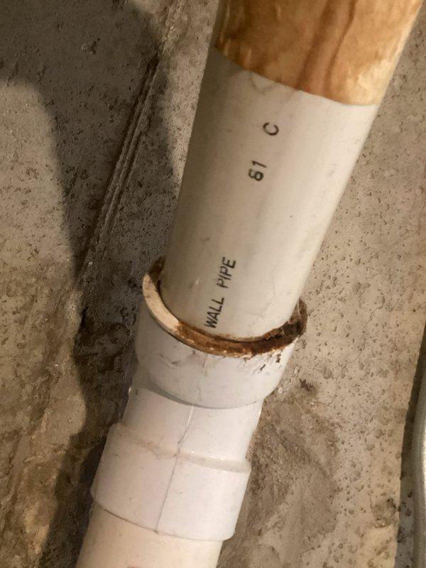 Provided project estimate for connecting water supply line to exterior hose bibb at 50-year-old single-family residence. Assessed existing basement plumbing infrastructure including white PVC drainage system with visible corrosion at pipe joints and connections near floor joists. Evaluated routing options from main water supply to proposed outdoor faucet location, considering existing pipe runs along concrete foundation walls and clearances around water heater. Documented current plumbing configuration and structural conditions to determine materials, labor requirements, and optimal installation pathway for new water supply connection.