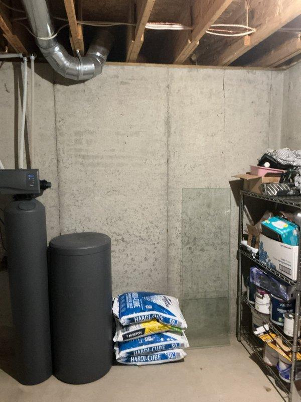 Conducted on-site assessment for water heater replacement in basement utility area. Evaluated existing tank-style water heater installation, plumbing connections, gas lines, venting requirements, and available space for potential relocation approximately several feet from current position. Documented existing conditions including water softener system, exposed ceiling joists, concrete block walls, PVC drainage and vent piping, gas supply lines, and electrical infrastructure. Reviewed both traditional tank-style and tankless water heater options with homeowner to determine optimal solution based on household hot water demands, available utilities, and spatial constraints. Provided comprehensive estimate covering equipment specifications, installation requirements, and necessary modifications to accommodate potential unit relocation.