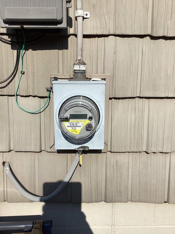 Conducted site evaluation for generator transfer switch installation at residential property. Documented existing electrical service configuration including outdoor meter installation with weatherproof enclosure and interior main breaker panel. Assessed current electrical infrastructure, conduit routing, and panel capacity to determine feasibility and requirements for transfer switch integration. Provided photographic documentation of meter base, service entrance conductors, grounding system, and main distribution panel for preparation of installation quote.