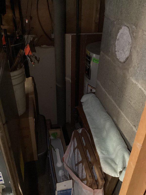 Conducted comprehensive inspection of aging water service connector system from main city line to 47-year-old residential property. Located and assessed connector point in basement utility area, documenting conditions with photographic evidence as requested. Inspection revealed exposed plumbing infrastructure in unfinished basement space with various utility systems present. Evaluated exterior drainage conditions around foundation perimeter where service line enters structure, noting moisture accumulation on patio pavers adjacent to building. Documented interior basement conditions including concrete wall penetration points, existing pipe routing, and accessibility for potential future service work. Provided detailed photographic documentation of both interior connector location and exterior grade conditions for estimate preparation purposes.
