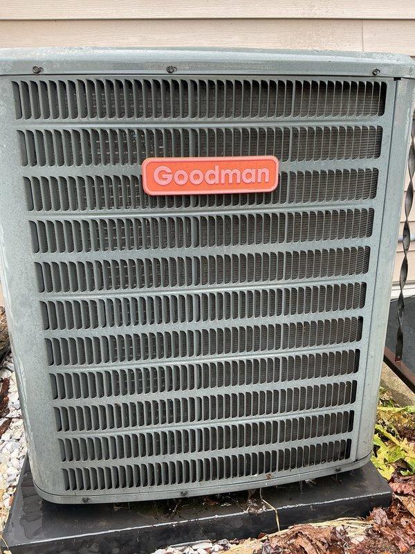 Responded to no cooling complaint on 2011 Amana residential air conditioning system. Upon arrival, performed visual inspection of outdoor condenser unit, which showed normal physical condition with clean coil fins and intact housing. Documented equipment condition with photographs showing Goodman-branded outdoor unit with minor dust accumulation in louvers but no visible damage, blockage, or component failure. Unit required diagnostic troubleshooting to determine root cause of complete cooling loss that began same day.
