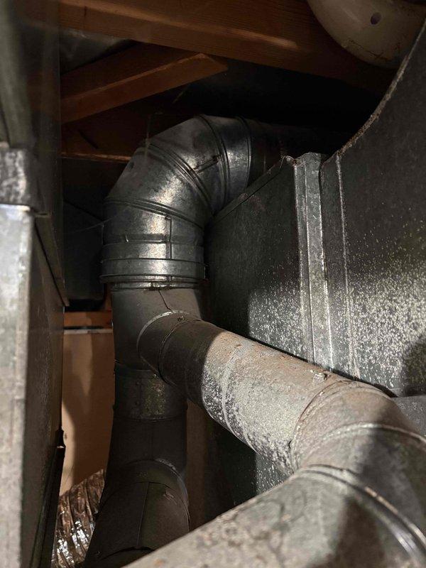 Conducted on-site assessment for new tank water heater installation in residential basement utility area. Evaluated existing water heater configuration, plumbing connections, venting system, and clearance requirements in relation to adjacent HVAC equipment. Documented current installation setup including pipe routing, gas connections, and exhaust ductwork for replacement specifications and provided estimate for complete water heater replacement.