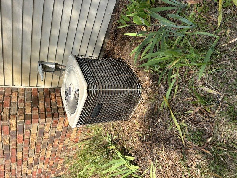 Completed comprehensive super tune-up service on 30-year-old air conditioning system. Removed heavy accumulation of organic debris, dried leaves, grass clippings, and plant material from evaporator coil and condenser unit exterior, restored proper airflow to heat exchanger components, and verified system operational performance.