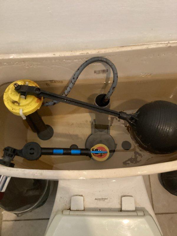 Responded to basement toilet leak that had been ongoing for several weeks in a 45-year-old residence. Upon inspection, found deteriorated flapper valve and corroded flush valve components with significant rust staining and mineral buildup in tank. Replaced faulty flapper assembly and fill valve components to resolve leak issue. Additionally completed dishwasher installation and hookup as requested during the same visit.