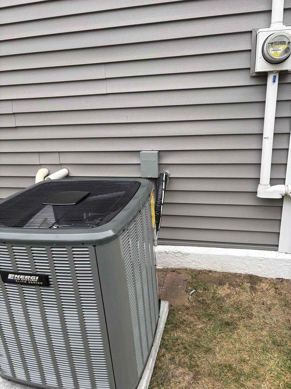Completed full air conditioning system replacement at residential property. Removed existing outdoor condensing unit and installed new high-efficiency AC condenser on concrete pad with proper refrigerant line connections and electrical disconnect. Installed new evaporator coil at furnace location in basement, integrated with existing gas furnace system. Ran refrigerant linesets through exterior wall with appropriate insulation and PVC line hide. Connected condensate drainage lines with proper pitch and termination. Installed new thermostat wiring and verified all electrical connections meet code requirements. Pressure tested refrigerant lines for leaks, evacuated system to proper vacuum levels, and charged unit to manufacturer specifications. Verified proper airflow across evaporator coil and through ductwork. Started system and confirmed cooling operation, checked temperature split across coil, and monitored system pressures during operation. Reviewed thermostat operation and system c