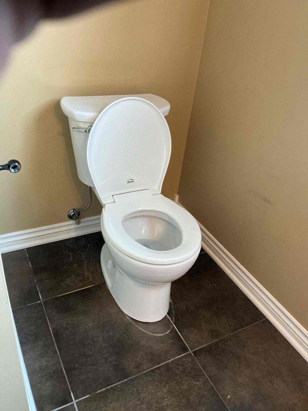 Completed toilet replacement in residential bathroom. Removed existing two-piece toilet and installed new white porcelain toilet unit in corner placement. Verified proper installation, water supply connection, and flush operation. Fixture is fully functional with no leaks detected.