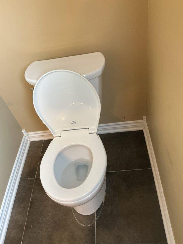 Completed toilet replacement in residential bathroom. Removed existing two-piece toilet and installed new white porcelain toilet unit in corner placement. Verified proper installation, water supply connection, and flush operation. Fixture is fully functional with no leaks detected.