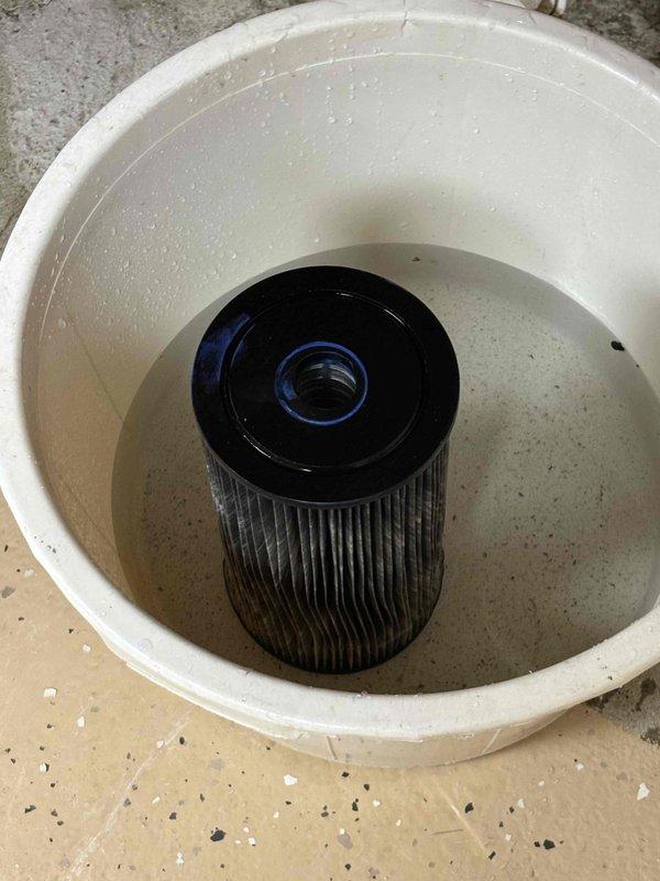 Responded to service call for whole house water filter replacement. Upon arrival, accessed the existing filtration system mounted on basement wall with copper supply lines and shut-off valves. Removed the old filter cartridge from the blue housing canister using appropriate tools. Installed client-provided replacement filter cartridge, ensuring proper seating and seal integrity. Reassembled the filter housing, purged air from the system, and verified all connections were secure with no leaks present. System restored to full operation with improved water flow.