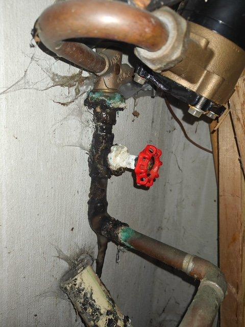 Responded to emergency service call for basement water line valve replacement and kitchen faucet installation, coordinated with municipal water shutoff schedule. Upon arrival, assessed heavily corroded main water line assembly in basement showing significant deterioration, black corrosion buildup, and green patina on copper components. Replaced deteriorated gate valve and associated corroded piping sections on main water supply line. Installed new shutoff valve assembly with proper mounting brackets and wall supports. Addressed mineral deposit accumulation and ensured proper pipe alignment throughout vertical configuration. Completed kitchen faucet replacement as requested. Restored water service to residence following municipal line reactivation, tested all connections for leaks, and verified proper operation of new valve and faucet installations.
