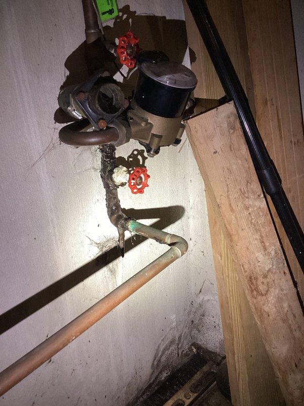 Responded to emergency service call for basement water line valve replacement and kitchen faucet installation, coordinated with municipal water shutoff schedule. Upon arrival, assessed heavily corroded main water line assembly in basement showing significant deterioration, black corrosion buildup, and green patina on copper components. Replaced deteriorated gate valve and associated corroded piping sections on main water supply line. Installed new shutoff valve assembly with proper mounting brackets and wall supports. Addressed mineral deposit accumulation and ensured proper pipe alignment throughout vertical configuration. Completed kitchen faucet replacement as requested. Restored water service to residence following municipal line reactivation, tested all connections for leaks, and verified proper operation of new valve and faucet installations.