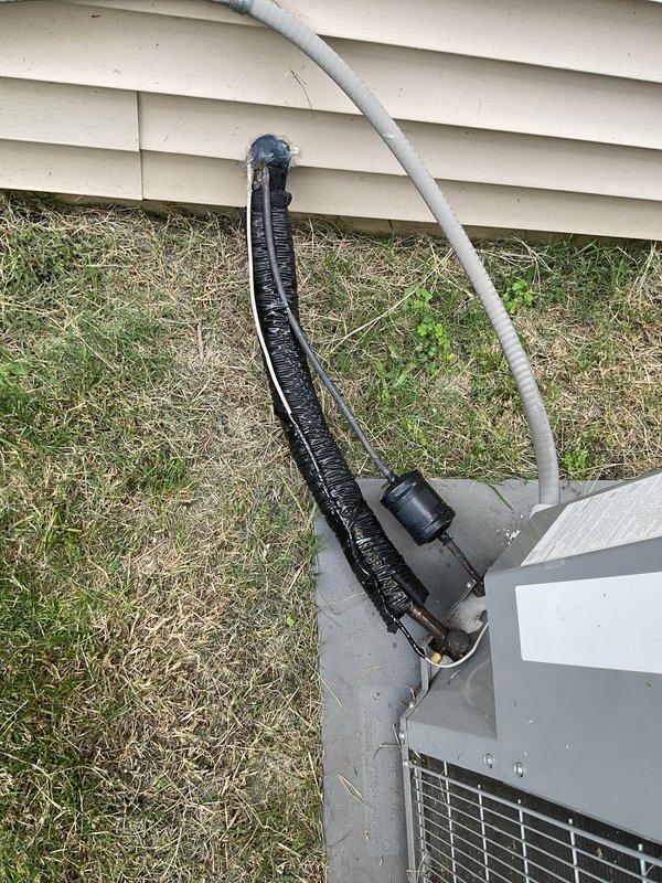Completed annual cooling maintenance on 10-year-old residential AC system. Customer reported intermittent squeaking noise from fan when operating in continuous mode rather than auto mode; unit continues to cool effectively with no performance issues. Performed standard tune-up procedures including inspection of outdoor condenser unit, refrigerant lines, and associated components. Examined insulated refrigerant line sets for wear and deterioration, noting some fraying of foam insulation material that may require future attention. Verified proper installation of condensate drain line and checked unit positioning on concrete pad. System operating within normal parameters at time of service; documented equipment condition with photos for service records.