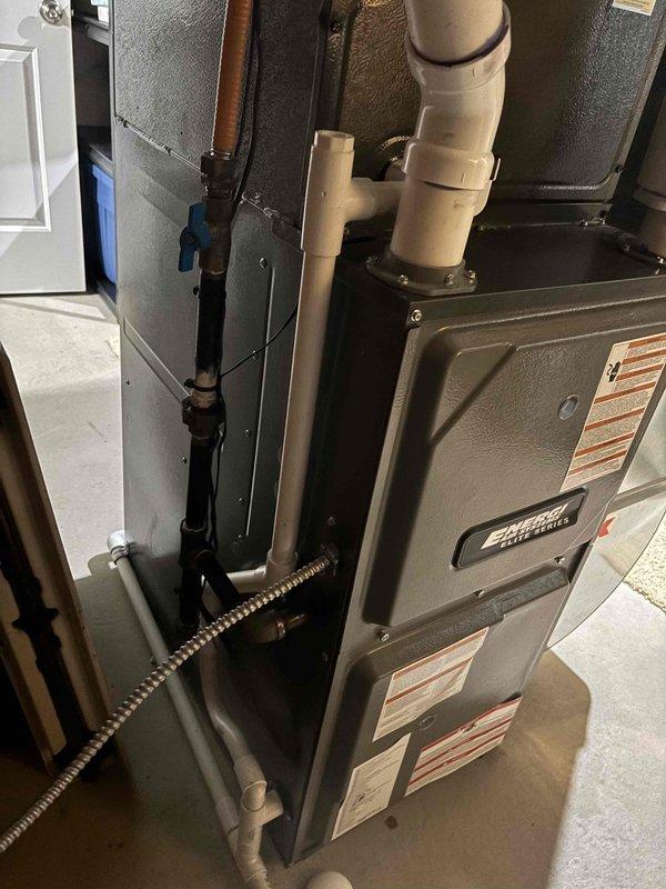 Responded to no cooling call on 2-year-old EnergiAir system. Upon arrival, performed diagnostic inspection of outdoor condenser unit and indoor air handler/furnace assembly. Documented equipment condition and surrounding installation environment, noting overgrown ornamental grass partially obstructing outdoor unit airflow. Captured photographic documentation of both outdoor condenser unit and indoor HVAC components for service records. System evaluated and findings communicated to customer with recommended next steps for restoration of cooling operation.