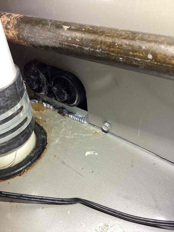 Responded to water leak call involving furnace system. Upon inspection, discovered severely corroded condensate drain line with extensive rust deterioration causing active leak. Documented corroded piping and moisture damage to surrounding HVAC components. Found standing water accumulated in drain pan beneath unit, indicating ongoing drainage issue. Photographed affected areas showing compromised pipe integrity and water collection in emergency pan. Recommended immediate replacement of corroded condensate line and evaluation of drain pan functionality to prevent further water damage to mechanical equipment and surrounding structure.