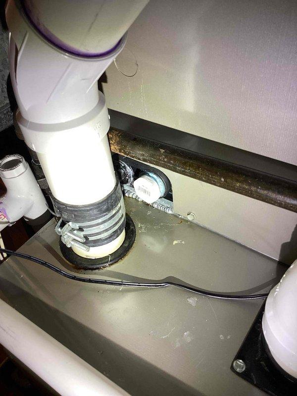 Responded to water leak call involving furnace system. Upon inspection, discovered severely corroded condensate drain line with extensive rust deterioration causing active leak. Documented corroded piping and moisture damage to surrounding HVAC components. Found standing water accumulated in drain pan beneath unit, indicating ongoing drainage issue. Photographed affected areas showing compromised pipe integrity and water collection in emergency pan. Recommended immediate replacement of corroded condensate line and evaluation of drain pan functionality to prevent further water damage to mechanical equipment and surrounding structure.