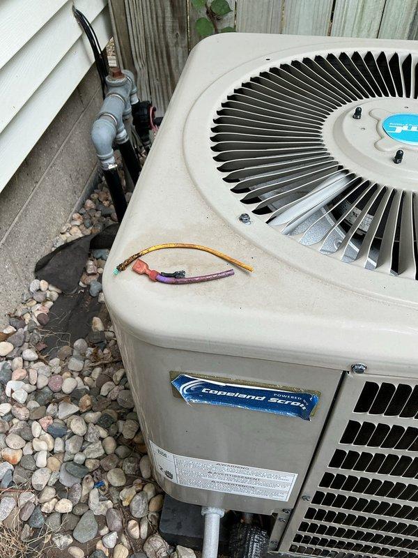 Responded to cooling complaint on 13-year-old Goodman system with insufficient cooling and indoor temperature rise. Upon arrival, discovered excessive condensation on evaporator plenum and ductwork, indicating potential airflow restriction or low refrigerant charge—consistent with previous service call. Inspected outdoor condenser unit and found exposed electrical wiring at top panel requiring immediate attention for safety and code compliance. Observed significant moisture accumulation described as "slimy water" on indoor components, confirming condensate drainage issue or secondary leak. Documented equipment condition with photographs showing weathered outdoor unit, condensation-covered plenum surfaces, and compromised wiring connections. Recommended immediate refrigerant leak detection and repair, proper securing of electrical connections, verification of condensate drain operation, and complete system evaluation given recurring cooling issues and age of equipment.