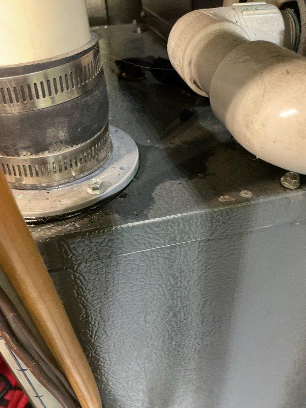 Responded to cooling complaint on 13-year-old Goodman system with insufficient cooling and indoor temperature rise. Upon arrival, discovered excessive condensation on evaporator plenum and ductwork, indicating potential airflow restriction or low refrigerant charge—consistent with previous service call. Inspected outdoor condenser unit and found exposed electrical wiring at top panel requiring immediate attention for safety and code compliance. Observed significant moisture accumulation described as "slimy water" on indoor components, confirming condensate drainage issue or secondary leak. Documented equipment condition with photographs showing weathered outdoor unit, condensation-covered plenum surfaces, and compromised wiring connections. Recommended immediate refrigerant leak detection and repair, proper securing of electrical connections, verification of condensate drain operation, and complete system evaluation given recurring cooling issues and age of equipment.