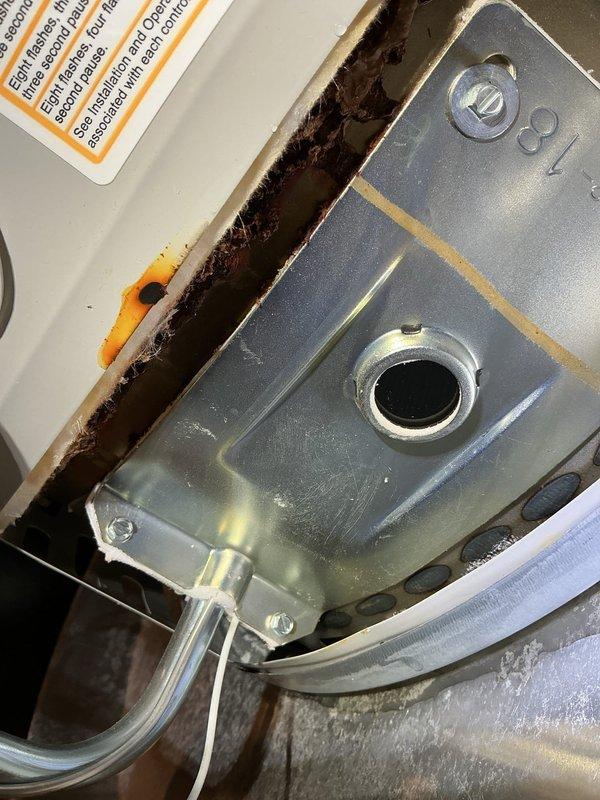 Responded to water heater leak with standing water present in drain pan. Upon inspection, confirmed active leakage from bottom of 3-year-old Bradford White unit. Documented gas valve assembly showing significant corrosion and water damage staining around control components, as well as plumbing configuration including PVC, copper, and PEX supply lines. Assessed unit condition and provided recommendations for repair or replacement based on extent of leak damage and age of equipment.
