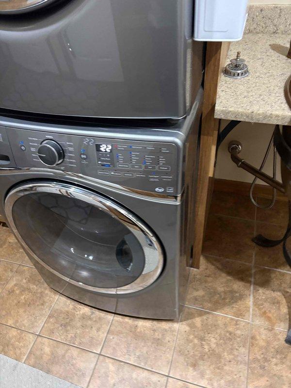 Responded to backed up drain issue in approximately 20-year-old residence. Upon arrival, inspected laundry area and bathroom fixtures based on customer report of drainage problems that began two days prior. Assessed washing machine drain line and vessel sink drainage system. Performed drain clearing procedures to restore proper flow and function. Tested both fixtures under running water conditions to verify complete resolution of backup issue. Photographed completed work showing operational washing machine and functional vessel sink with proper drainage.