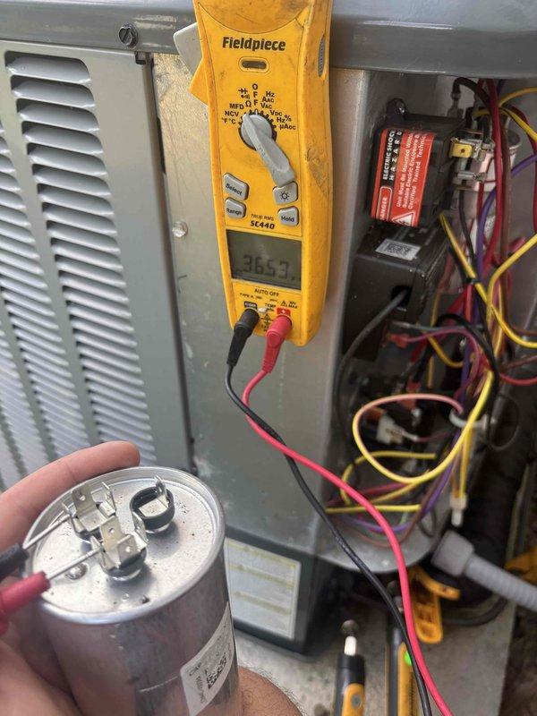 Completed annual cooling maintenance and tune-up on 2020 Energi Air system under 5-year warranty coverage. Performed comprehensive system inspection including capacitor testing with digital multimeter, which confirmed proper operation at 365 microfarads. Inspected and cleared condensate drain assembly, noting accumulated debris and mineral deposits that were addressed during service. All electrical components, connections, and safety controls tested and verified operational. System operating within manufacturer specifications upon completion.