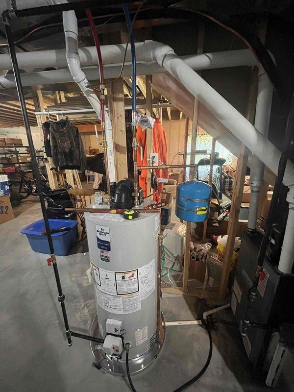 Successfully installed a 50-gallon power vent natural gas water heater in the basement utility area. Connected all necessary water supply lines, gas lines, and venting systems according to manufacturer specifications and local code requirements. Integrated the new unit with the existing pressure tank and plumbing infrastructure, ensuring proper operation of all components.