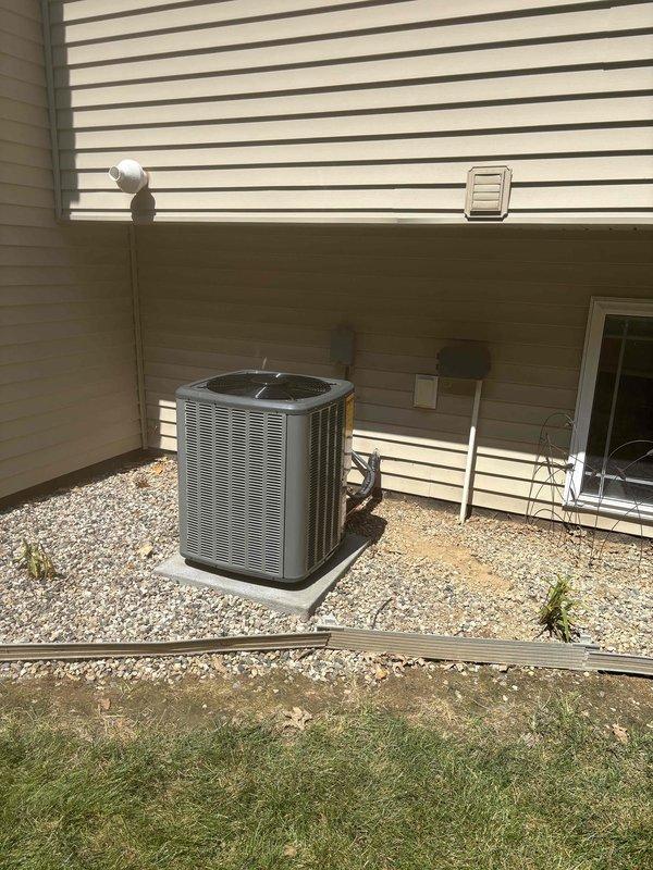 Completed full HVAC system installation including new black furnace unit with PVC venting and drainage piping configuration in basement utility area. Installed outdoor condensing unit on prepared gravel pad with proper electrical disconnect and secure mounting. Connected metallic ductwork to furnace, ensured all venting meets code requirements, and verified system operational with proper airflow and refrigerant charge.