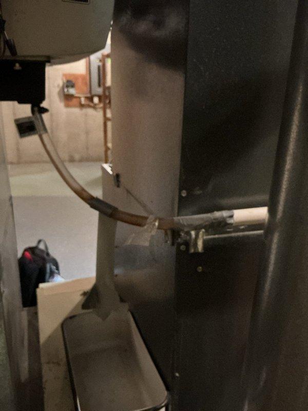 Responded to water leak inside 15-year-old furnace unit. Upon inspection, discovered extensive rust and corrosion throughout the base drain pan with standing water accumulation, indicating prolonged moisture exposure and deterioration of the metal surfaces. Documented the severe rust damage affecting the interior base section of the HVAC system. Performed AC tune-up service on the system, which remained operational for heating despite the leak condition. Photographed the corroded drain pan, standing water, and overall equipment condition for service records.