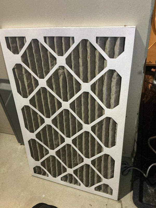 Responded to no cool call and found moisture detected in furnace with red sensor light illuminated. Upon inspection, discovered water accumulation in bottom of Energy Systems Elite Series furnace unit. Investigated condensate drainage system including PVC and copper piping connections at base of unit. Removed and inspected air filter which appeared clean and in good condition. Addressed moisture issue and cleared sensor fault to restore normal system operation.