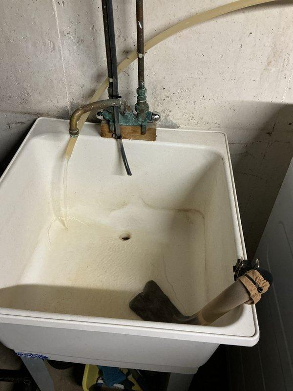 Responded to ongoing water softener issue where salt pellets were converting to mush in brine tank since November 2024. Inspected Peerless water softener system including control head, resin tank, and brine reservoir. Evaluated salt bridge formation and mushing condition in gray brine tank, noting customer had used same salt brand successfully for two years prior without issue. Examined control valve programming, regeneration cycle settings, and brine draw system operation. Assessed water hardness levels and system performance parameters. Photographed installation including digital control head display, plumbing connections, brine tank condition with visible salt media, and utility sink area showing mineral staining indicative of water quality concerns. Discussed findings with customer regarding persistent salt mushing despite previous service attempts by other technician who attributed problem to salt quality. Reviewed system age and repair history, noting this was fourth service call