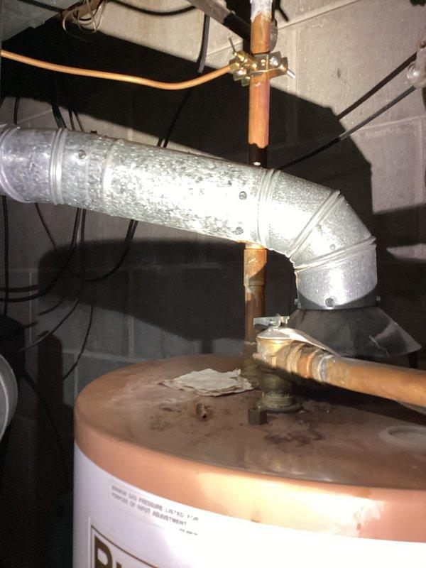 Conducted on-site assessment of broken sewer pipe in basement causing water outage to two bathrooms. Documented existing plumbing infrastructure including water heater connections, copper supply lines, HVAC ductwork with condensation issues, and utility room configuration. Photographed mechanical installations to provide comprehensive project estimate for sewer line repair and restoration of water service to affected fixtures.