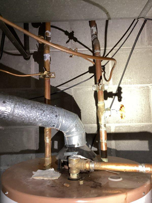 Conducted on-site assessment of broken sewer pipe in basement causing water outage to two bathrooms. Documented existing plumbing infrastructure including water heater connections, copper supply lines, HVAC ductwork with condensation issues, and utility room configuration. Photographed mechanical installations to provide comprehensive project estimate for sewer line repair and restoration of water service to affected fixtures.