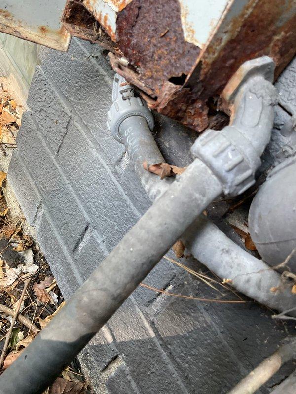 Completed annual cooling maintenance on 31-year-old York AC unit. Performed comprehensive system inspection including condenser coil assessment, which showed significant debris accumulation and dirt buildup on fins. Documented existing rust deterioration on metal components near condensate drain system and PVC drainage lines at foundation level. Unit operational at time of service, though customer is aware of system age and planning replacement within the next year.