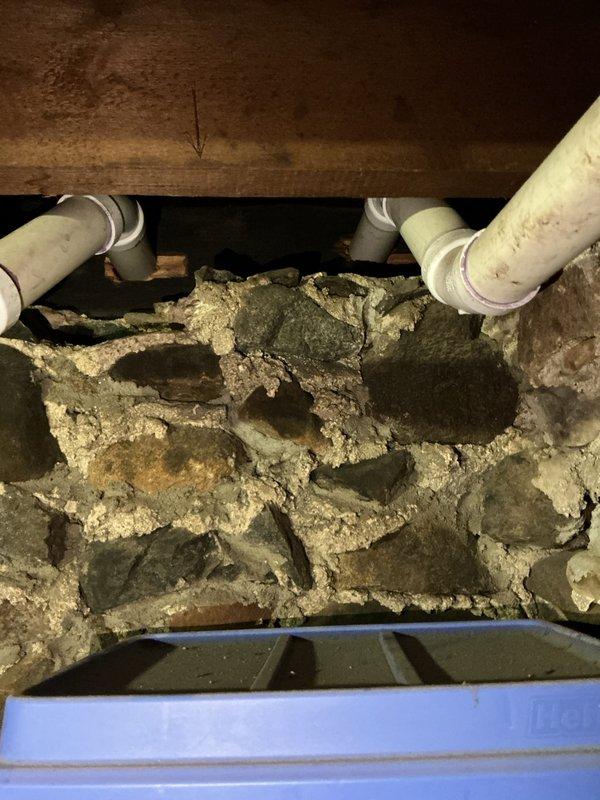 Completed rental inspection of single furnace system with no water heater present. Accessed mechanical equipment through rear basement entry as thermostat was not accessible during visit. Inspected and documented HVAC piping components including PVC supply lines with proper fittings and connections within mechanical cabinet, along with associated ductwork and mounting hardware. Examined basement foundation area including stone masonry construction, floor joists, plumbing drainage lines, and ventilation access points to assess overall system installation and structural conditions.