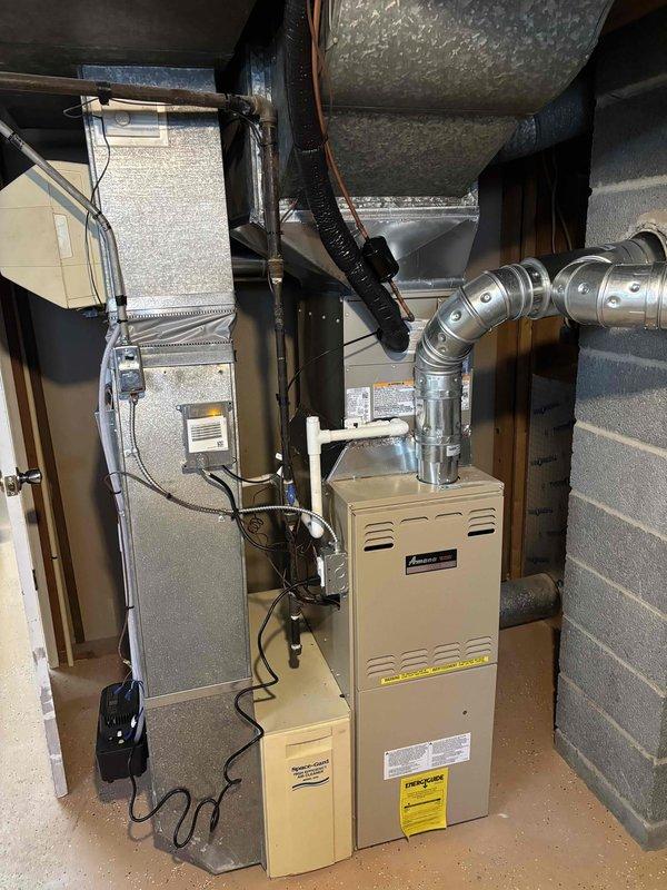 Completed full HVAC system replacement in residential basement utility area. Removed existing equipment and installed new air handler unit and furnace system with proper clearances and mounting. Routed and secured copper refrigerant lines with appropriate brackets, installed metallic supply ductwork with reinforced connections, and connected flexible insulated ducting. Ran electrical conduit and power supply to both units per code requirements. Installed pressure relief valve with PVC discharge piping on water heater. Verified all connections, tested system operation, and confirmed proper airflow through duct system.
