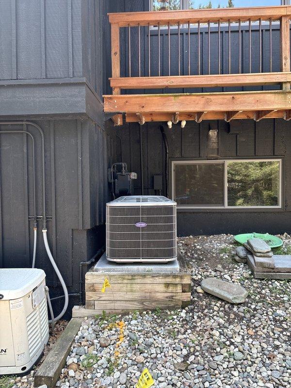 Completed full HVAC system replacement including installation of new Carrier furnace unit in mechanical room with proper ductwork connections and condensate drain lines. Installed new outdoor condenser unit on wooden platform beneath deck with appropriate clearances and utility connections. All equipment tested and verified operational upon completion.