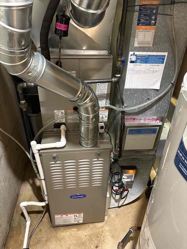 Completed full HVAC system replacement including installation of new Carrier furnace unit in mechanical room with proper ductwork connections and condensate drain lines. Installed new outdoor condenser unit on wooden platform beneath deck with appropriate clearances and utility connections. All equipment tested and verified operational upon completion.