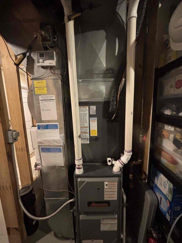 Completed full HVAC system replacement including installation of new air handler and furnace unit in interior utility space with associated PVC condensate drainage lines and electrical connections. Installed new outdoor condenser unit on concrete pad with proper electrical disconnect and connection to existing power supply. All refrigerant lines connected and insulated, thermostat wired and programmed, system tested and verified operational.