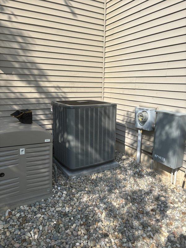 Completed full HVAC system replacement including installation of new air handler and furnace unit in interior utility space with associated PVC condensate drainage lines and electrical connections. Installed new outdoor condenser unit on concrete pad with proper electrical disconnect and connection to existing power supply. All refrigerant lines connected and insulated, thermostat wired and programmed, system tested and verified operational.