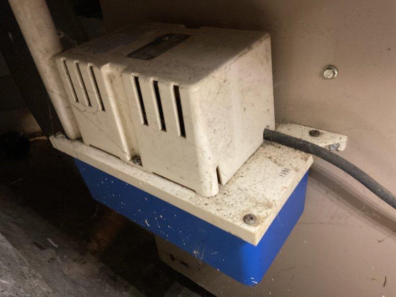 Completed annual cooling maintenance on a 2011 International Comfort Products system. Performed comprehensive tune-up including inspection of outdoor condenser unit, which showed significant dirt and debris accumulation on protective grille. Inspected indoor condensate pump assembly with blue reservoir tank, noting moderate dust buildup but confirming functional operation. Verified best contact number on file and documented system condition with photographs for service records.