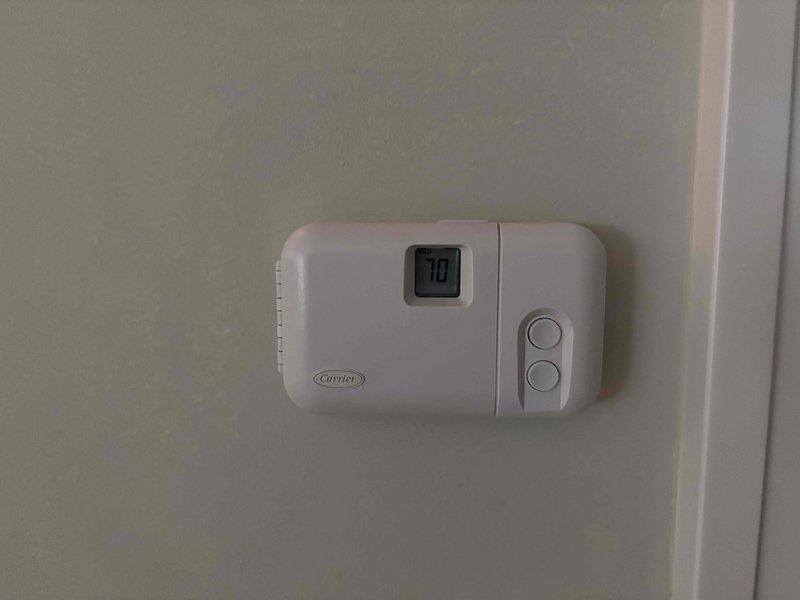 Completed annual cooling maintenance on 7-year-old EnergiAir system with warranty coverage through September 2027. Inspected Carrier thermostat and Comfort Zone II control system, verified proper temperature display and control functionality, and documented equipment condition through photo records. All components operating within normal parameters.