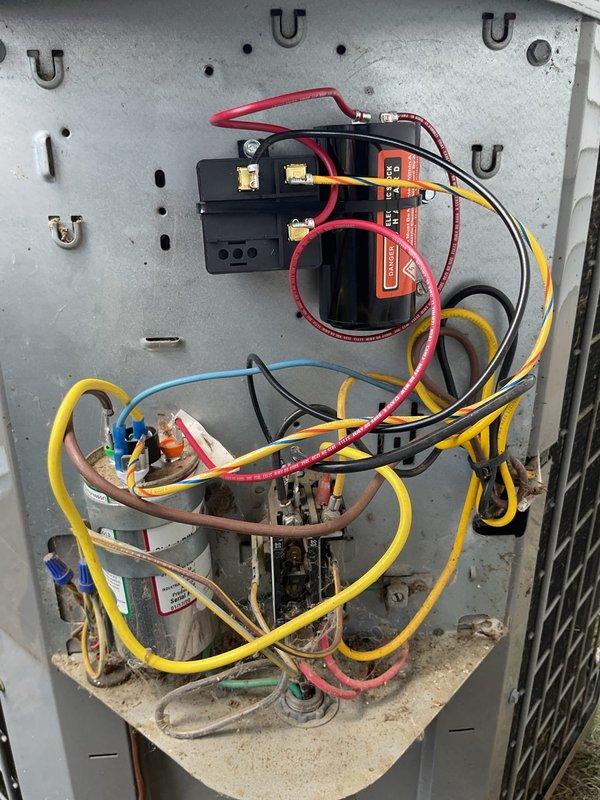 Completed annual cooling maintenance and tune-up on 17-year-old Heil air conditioning system with coil manufactured in 2014. Performed comprehensive inspection of electrical control panel, capacitor, and all associated wiring connections; verified proper operation of contactor and relay components; documented system condition with photos showing typical age-related wear but functional electrical assembly.