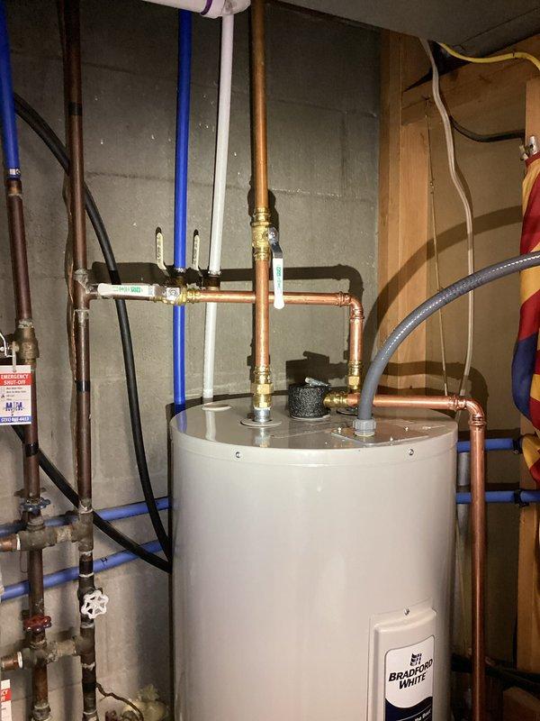 Successfully installed a 50-gallon electric water heater (tall tank, 59" height) in the basement utility area. All copper supply lines, brass fittings, shut-off valves, and electrical connections were properly installed and tested for functionality. The installation includes a 6-year parts warranty and 1-year labor warranty.