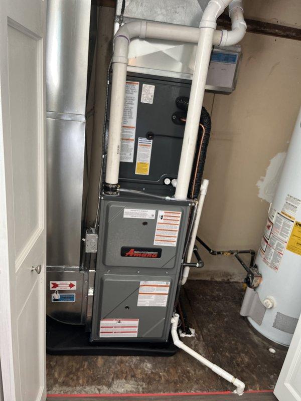 Completed full HVAC system installation including new Amana furnace and air conditioning unit with A2L refrigerant safety-rated outdoor condenser. Installed evaporator coil, established refrigerant line connections with proper insulation, configured PVC condensate drainage system, and integrated all ductwork connections. Verified proper equipment placement in mechanical room, completed all electrical connections, tested system operation, and documented installation with photos showing both indoor and outdoor components functioning correctly.