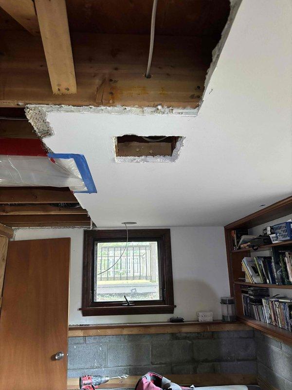 Completed comprehensive two-day structural ceiling repair involving removal of damaged drywall sections to expose and assess ceiling joists and framing members. Installed new diagonal bracing and reinforcement supports between existing joists to strengthen compromised ceiling structure. Removed deteriorated materials, secured all framing connections, and protected furnishings with plastic sheeting throughout the work area. Created access openings to address structural concerns and prepare surfaces for final drywall installation and finishing work.