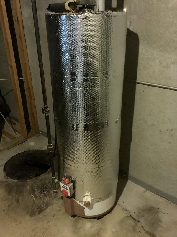 Responded to service call for sump pump system unable to keep up with washing machine discharge. Upon inspection, found dual-pipe sump pump installation with visible water accumulation in pit and moisture staining on surrounding concrete floor indicating inadequate pumping capacity or potential system malfunction. Documented existing conditions including pump configuration, electrical connections, and evidence of water management issues in basement utility area.