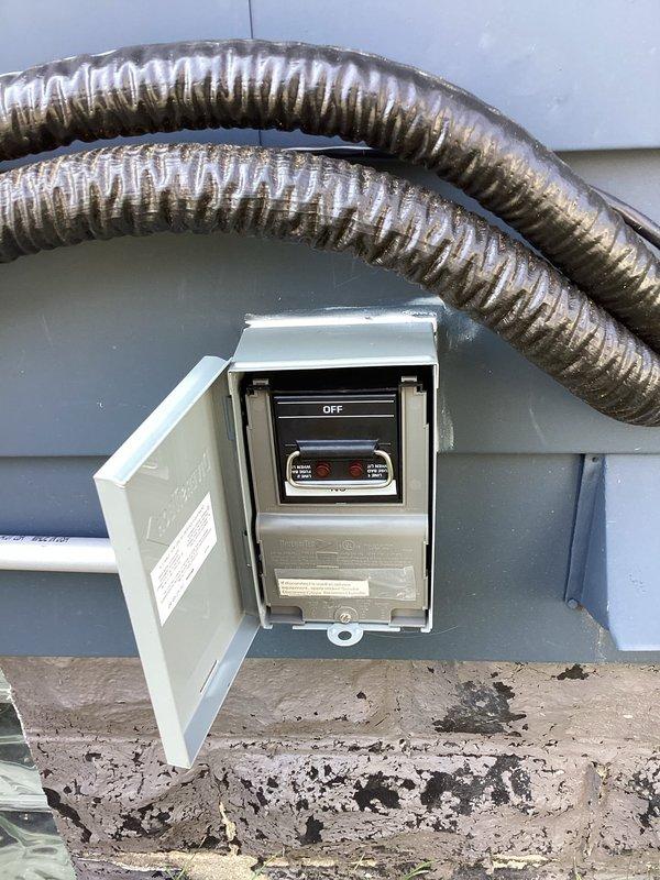 Completed installation of ductless mini-split system on exterior of building. Installed outdoor condensing unit with weatherproof electrical disconnect box and dedicated 220V circuit with appropriate breaker protection. Mounted line set with insulated refrigerant lines running through exterior wall penetration, secured flexible metallic ductwork along exterior siding. Verified proper electrical connections, tested system operation, and confirmed all safety controls functioning correctly.