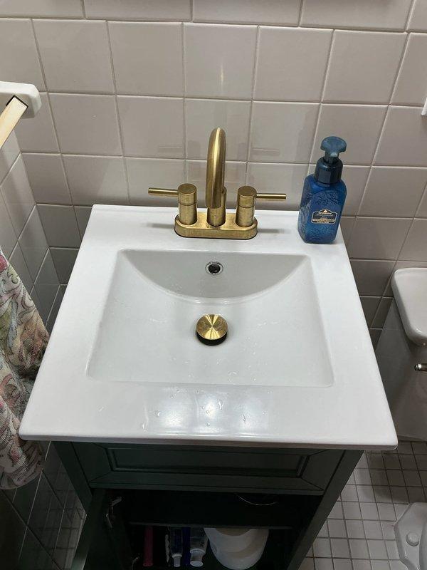 Responded to a plumbing leak at a bathroom sink hot water supply line. Upon inspection, identified the source of the leak in the supply connection beneath the vanity. Tightened the compression fitting on the hot water supply line to the faucet, eliminating the leak. Verified proper operation of the brass faucet assembly and confirmed no additional moisture or dripping from supply lines or P-trap assembly. System tested and restored to normal operation.