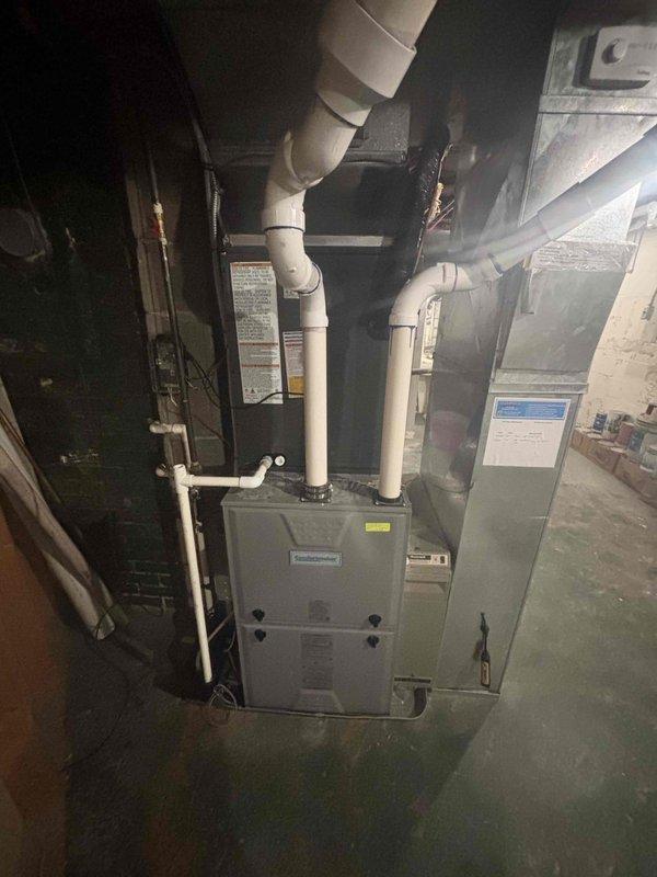 Completed full AC system replacement at residential property. Removed existing outdoor condensing unit and installed new unit against exterior wall with proper clearances. Connected refrigerant lines to indoor air handler located in basement mechanical room adjacent to existing furnace. Installed new condensate drainage piping using PVC, routed vertically through ceiling joists. Verified all electrical connections, tested system operation, and confirmed proper refrigerant charge and airflow. System commissioned and left in full working order.