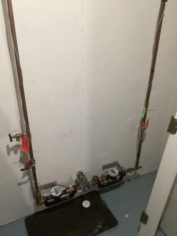 Responded to water leak report from 7-year-old Daikin furnace. Upon inspection, located leak source at plumbing connections near HVAC equipment in utility area. Documented existing water supply lines with brass fittings, flow meters, and shut-off valves with identification tags. Furnace remained operational throughout service call. Captured photographic documentation of affected area and plumbing configuration for service records.
